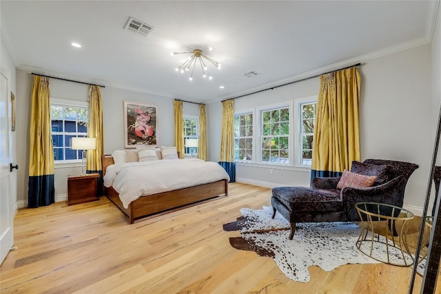 bedroom featuring wood finished floors, visible vents, a notable chandelier, and ornamental molding