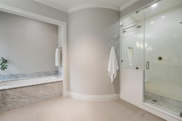 full bath featuring baseboards, tile patterned flooring, a shower stall, crown molding, and a garden tub