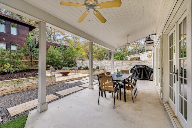 view of patio with a fenced backyard, grilling area, outdoor dining space, and a ceiling fan