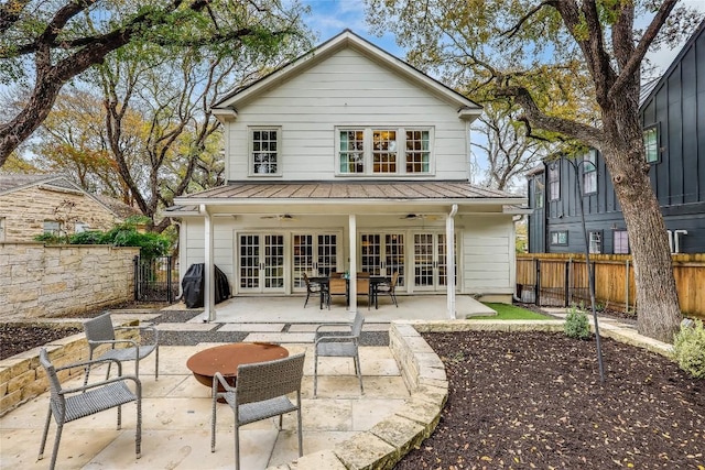 back of property featuring ceiling fan, french doors, and a patio