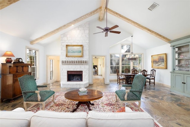 living room featuring ceiling fan, beam ceiling, a stone fireplace, and high vaulted ceiling