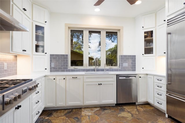 kitchen with white cabinets, backsplash, stainless steel appliances, and sink