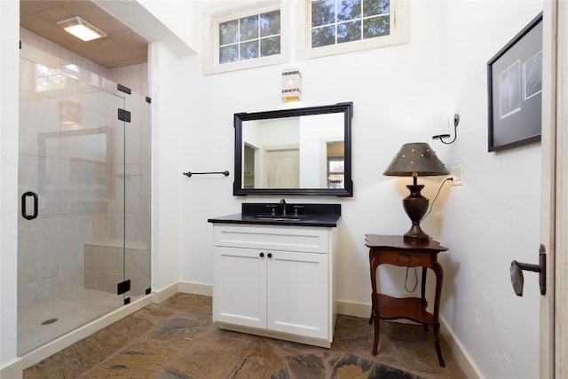 bathroom with vanity and a shower with shower door