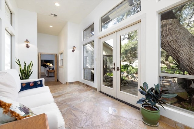 doorway to outside with a high ceiling and french doors