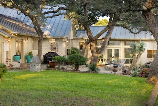 back of property featuring a patio area and a lawn