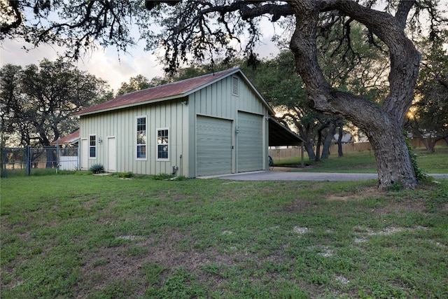 garage featuring a yard and a carport