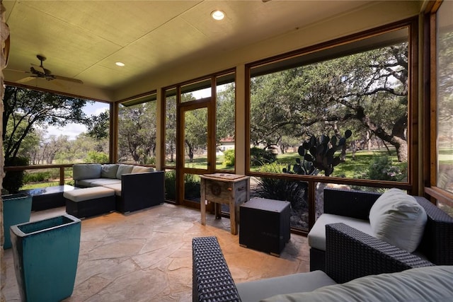 sunroom featuring ceiling fan