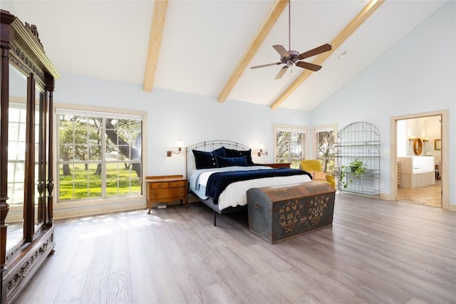 bedroom featuring ensuite bathroom, ceiling fan, beam ceiling, high vaulted ceiling, and light hardwood / wood-style floors