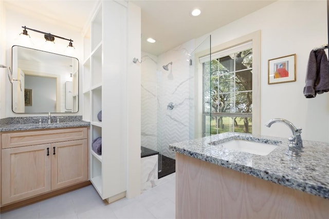 bathroom with vanity and tiled shower