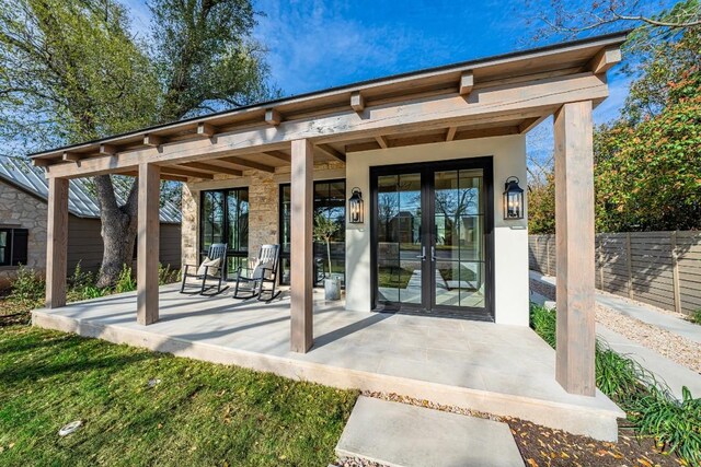 property entrance featuring french doors and covered porch