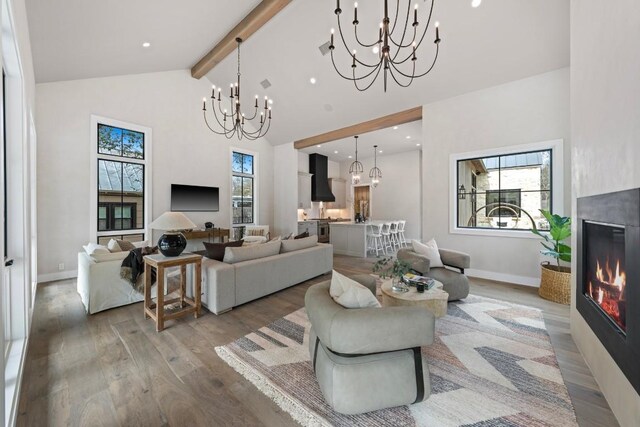 living room featuring hardwood / wood-style flooring, plenty of natural light, a fireplace, and high vaulted ceiling