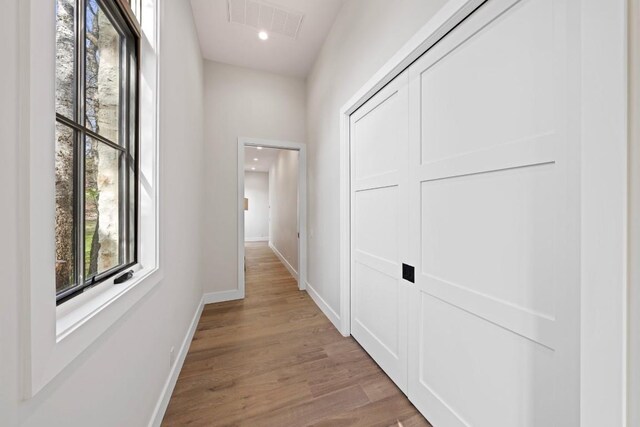 hall with light hardwood / wood-style floors