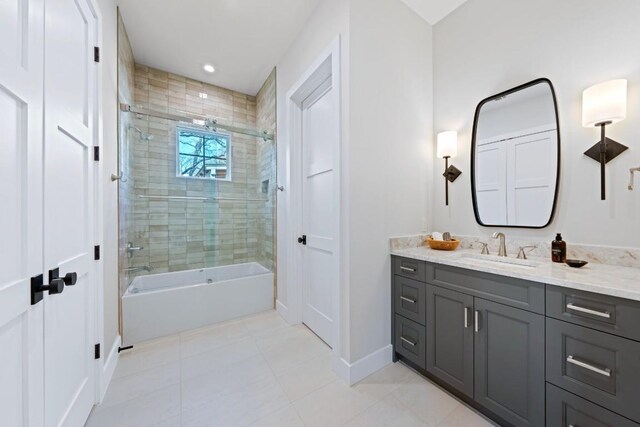 bathroom with tile patterned floors, vanity, and bath / shower combo with glass door