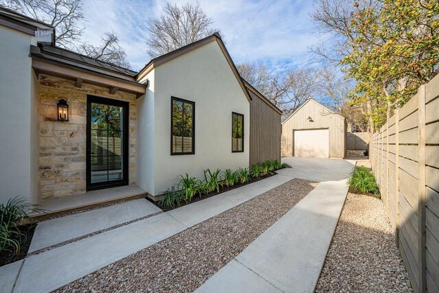 view of home's exterior featuring a garage and an outdoor structure