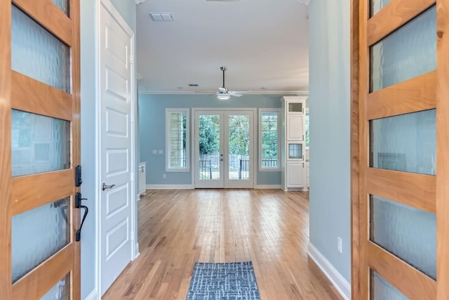 entryway with french doors, light hardwood / wood-style flooring, ceiling fan, and ornamental molding