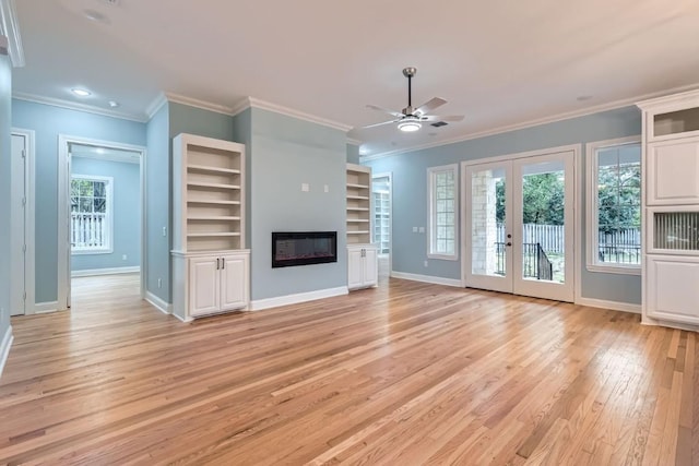 205 Vitex Dr, Lakeway, TX 78734 - unfurnished living room featuring light wood-style flooring, a ceiling fan, a glass covered fireplace, baseboards, and ornamental molding