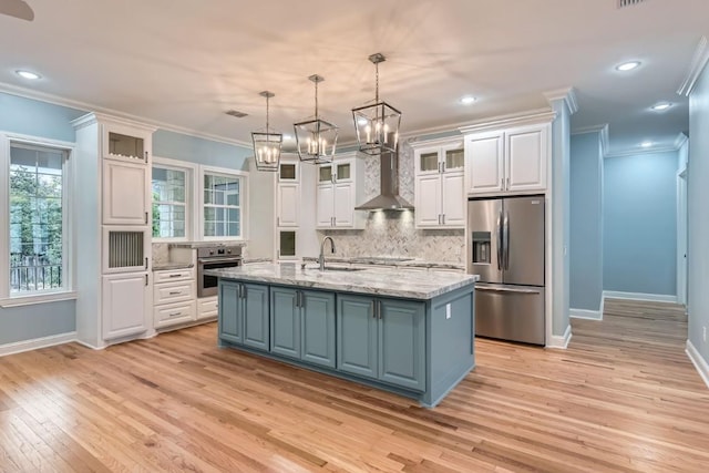 kitchen with white cabinets, a kitchen island with sink, and appliances with stainless steel finishes