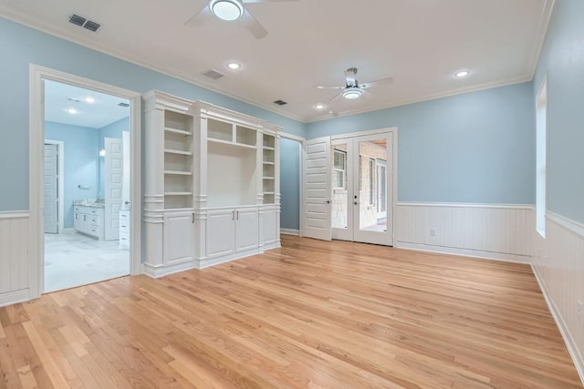 interior space with crown molding, french doors, ceiling fan, and light wood-type flooring