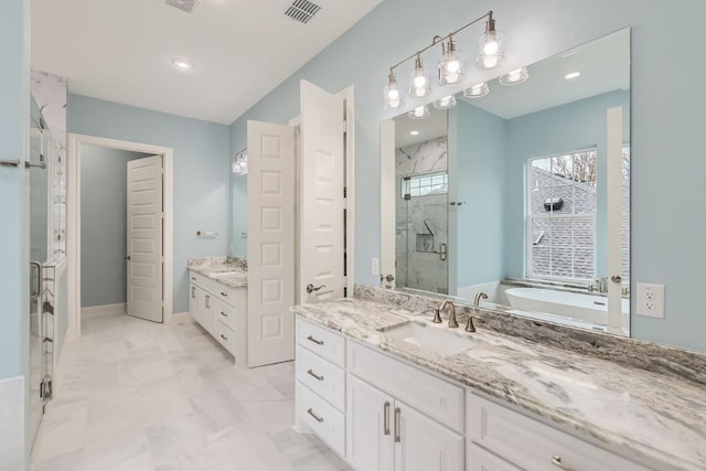 205 Vitex Dr, Lakeway, TX 78734 - bathroom with a marble finish shower, two vanities, a bathtub, marble finish flooring, and recessed lighting