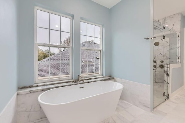 bathroom featuring shower with separate bathtub