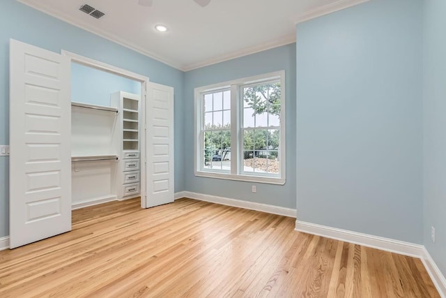 unfurnished bedroom featuring a closet, light hardwood / wood-style flooring, and ornamental molding