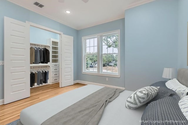 bedroom with hardwood / wood-style floors and a closet