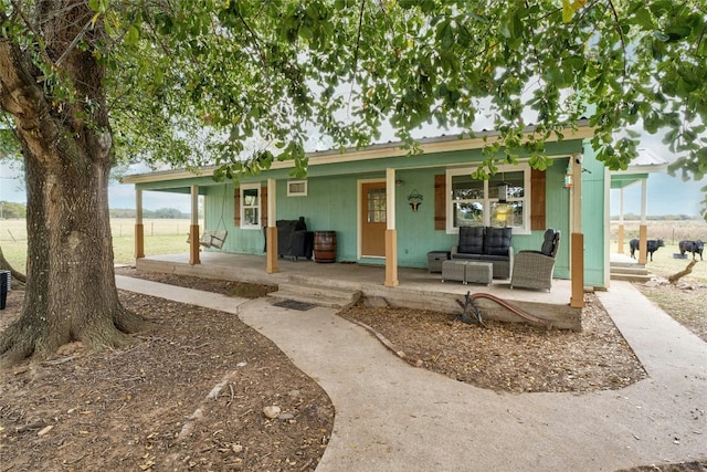 back of house featuring covered porch