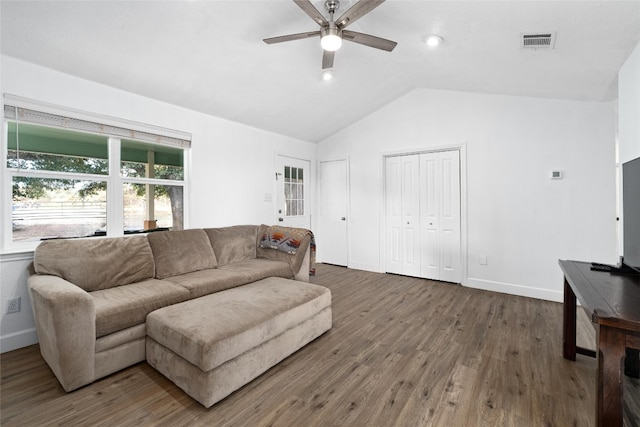 living room featuring ceiling fan, dark hardwood / wood-style flooring, and vaulted ceiling