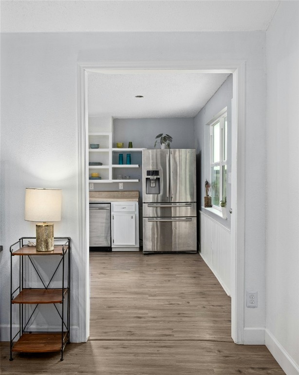 kitchen featuring appliances with stainless steel finishes and hardwood / wood-style flooring