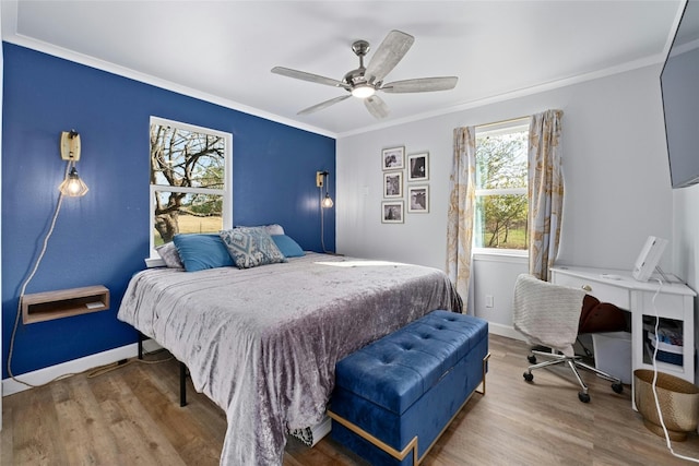 bedroom with hardwood / wood-style floors, ceiling fan, and ornamental molding