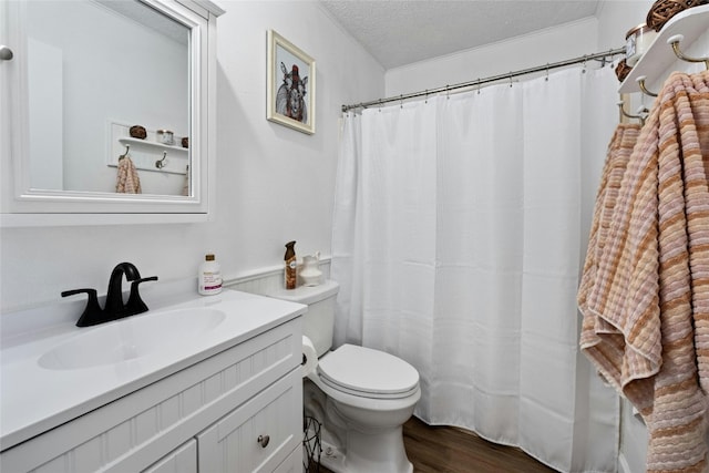 bathroom featuring vanity, hardwood / wood-style floors, a textured ceiling, and toilet