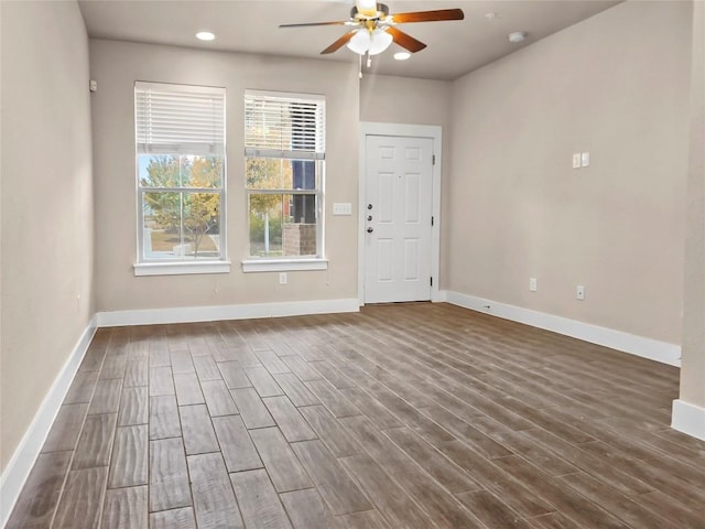 empty room featuring ceiling fan and dark wood-type flooring