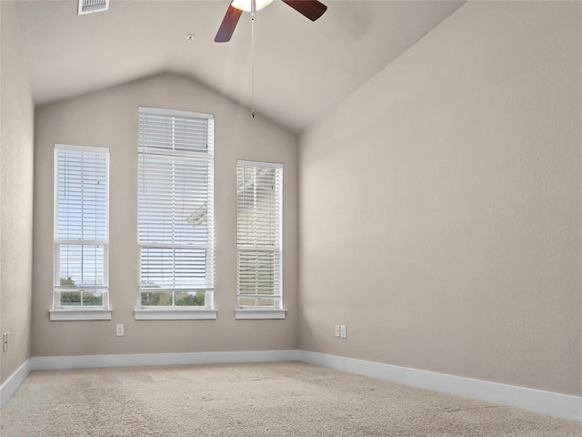 carpeted empty room featuring ceiling fan and vaulted ceiling