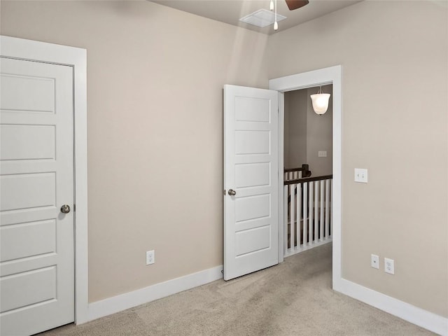 spare room with light colored carpet and ceiling fan