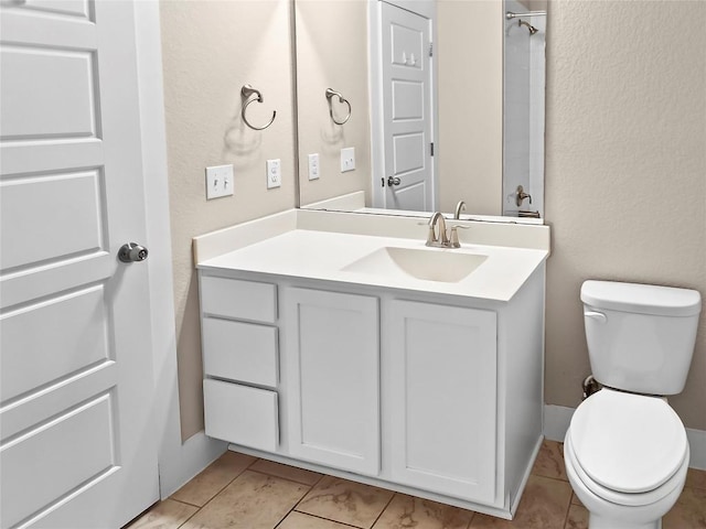 bathroom featuring toilet, vanity, and tile patterned floors