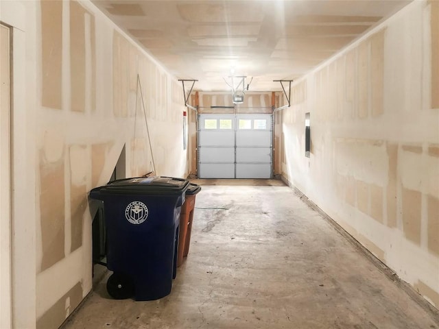 garage with electric panel and a garage door opener