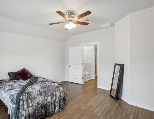 bedroom with connected bathroom, dark hardwood / wood-style floors, and ceiling fan