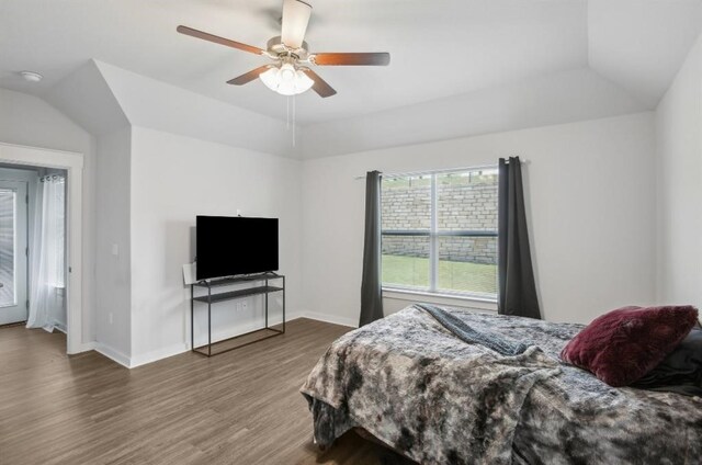 bedroom with ceiling fan, wood-type flooring, and lofted ceiling