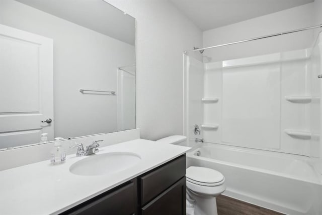 full bathroom featuring hardwood / wood-style floors, vanity, shower / bath combination, and toilet