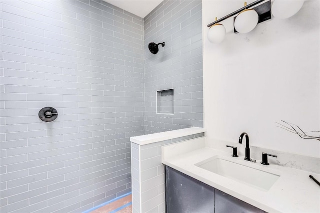 bathroom with sink and tiled shower