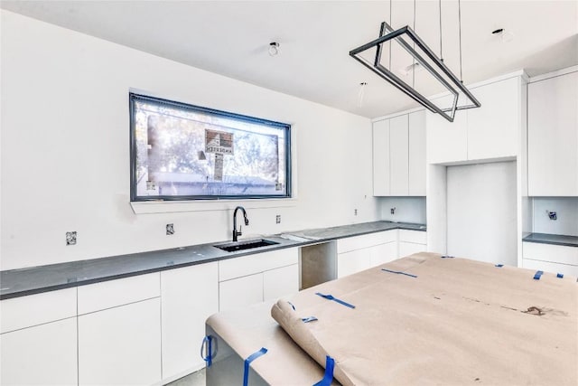 kitchen featuring white cabinets and sink