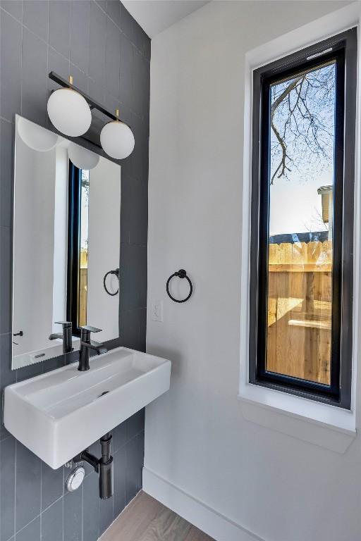 bathroom featuring baseboards and a sink