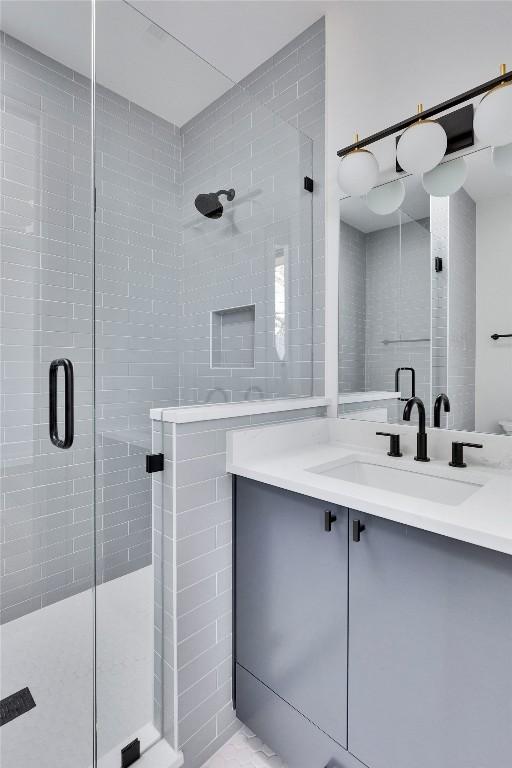 full bathroom featuring a stall shower and vanity