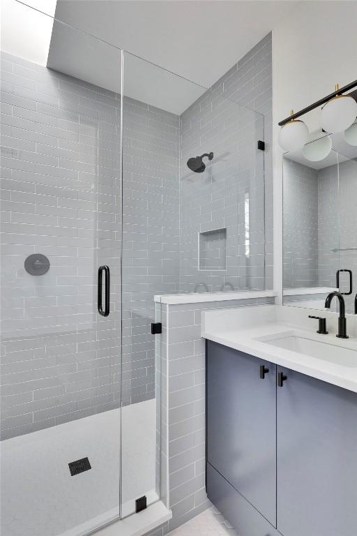 full bathroom featuring a stall shower and vanity