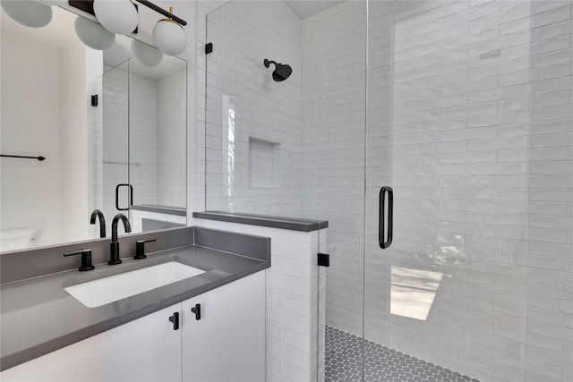 full bath with vanity and a shower stall