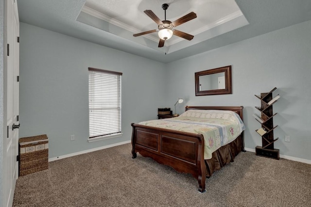 bedroom with carpet floors, a tray ceiling, ceiling fan, and ornamental molding