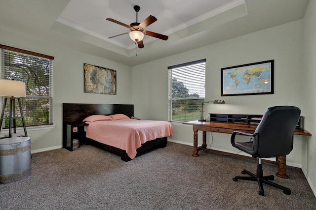 carpeted bedroom featuring ceiling fan, crown molding, and a tray ceiling