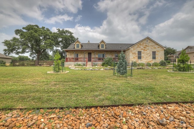 rear view of property featuring a lawn