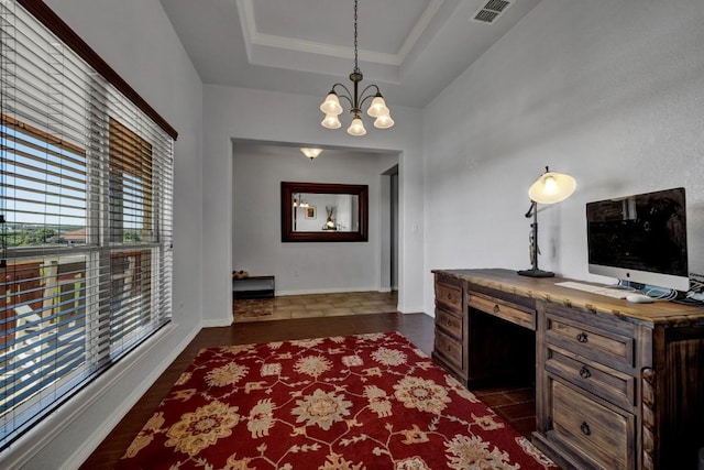 office space featuring a chandelier, a raised ceiling, and crown molding