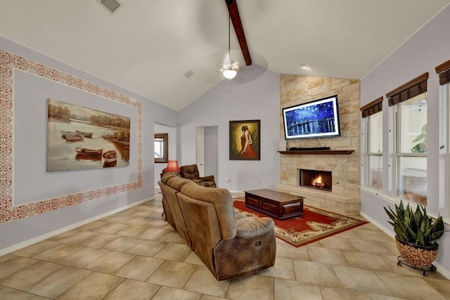 living room featuring ceiling fan, high vaulted ceiling, beamed ceiling, a stone fireplace, and light tile patterned flooring